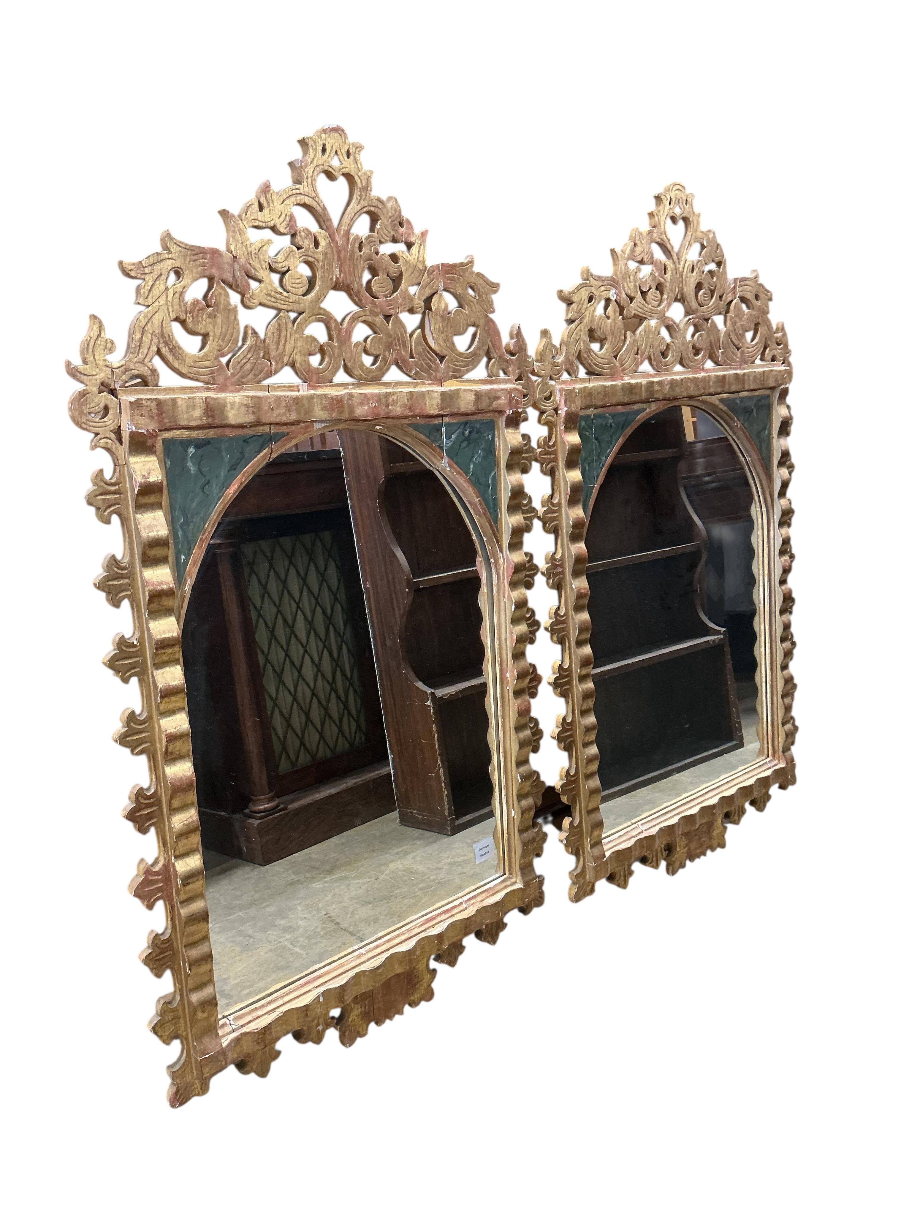 A pair of Italian painted carved giltwood wall mirrors, width 72cm, height 125cm